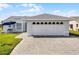 Traditional-style home featuring a two-car garage with a brick paved driveway and manicured lawn at 530 Eastlake Dr, Haines City, FL 33844