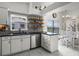 Open kitchen boasts modern appliances, marble floors and a dining area with large windows at 530 Eastlake Dr, Haines City, FL 33844