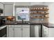 Modern kitchen with stainless steel appliances, ample countertop space, and open shelving at 530 Eastlake Dr, Haines City, FL 33844
