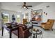 Bright living room with a ceiling fan, marble tile floors, modern decor, and bright windows at 530 Eastlake Dr, Haines City, FL 33844