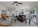 Spacious living room featuring neutral tones, ceiling fan, bright windows, and contemporary decor at 530 Eastlake Dr, Haines City, FL 33844