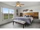 Spacious main bedroom with ceiling fan, decorative wall art, and a large window view at 530 Eastlake Dr, Haines City, FL 33844