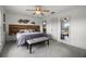Spacious main bedroom with ceiling fan, decorative wall art, and a large window view at 530 Eastlake Dr, Haines City, FL 33844