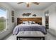 Spacious main bedroom with ceiling fan, decorative wall art, and a large window view at 530 Eastlake Dr, Haines City, FL 33844