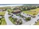 Aerial view of golf cart parking and the clubhouse with a lake in the background at 5341 Hogan Ln, Winter Haven, FL 33884