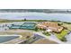 Aerial view of the community clubhouse, tennis courts and lake at 5341 Hogan Ln, Winter Haven, FL 33884