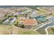 Aerial shot showcases the clubhouse, pool, tennis courts and community layout at 5341 Hogan Ln, Winter Haven, FL 33884
