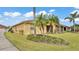Back exterior of home, featuring a screened in lanai and tropical landscaping at 5341 Hogan Ln, Winter Haven, FL 33884