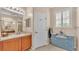 Well-lit bathroom featuring a vanity, shower access, and charming window with shutters at 5341 Hogan Ln, Winter Haven, FL 33884
