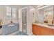 Bathroom featuring a walk-in shower, vanity, and a bright window at 5341 Hogan Ln, Winter Haven, FL 33884