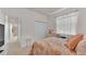 Cozy bedroom featuring a bed, closet, and window adorned with lace curtains at 5341 Hogan Ln, Winter Haven, FL 33884