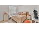 Bright bedroom with floral bedding, side tables, and natural light creates a cozy and inviting atmosphere at 5341 Hogan Ln, Winter Haven, FL 33884