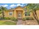 Inviting front entrance with a glass door, manicured landscaping, and a brick pathway leading to the home at 5341 Hogan Ln, Winter Haven, FL 33884