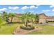 Lovely front yard showcasing lush landscaping, green grass, and a charming single-Gathering home at 5341 Hogan Ln, Winter Haven, FL 33884