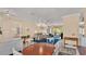 Bright living room with stylish chandelier, wood-look floors, and seamless flow to outdoor spaces at 5341 Hogan Ln, Winter Haven, FL 33884