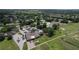 A lovely aerial view of the community clubhouse, pool, tennis courts, golf course, and surrounding residences at 571 Saint Andrews Rd, Winter Haven, FL 33884