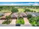Aerial shot of homes showcasing well-maintained yards and proximity to a lush golf course, highlighting the community's appeal at 571 Saint Andrews Rd, Winter Haven, FL 33884
