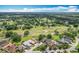 Neighborhood aerial view with a golf course, mature trees, and a scenic pond at 571 Saint Andrews Rd, Winter Haven, FL 33884