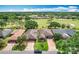 Neighborhood aerial view with manicured lawns, mature trees, and golf course in the background at 571 Saint Andrews Rd, Winter Haven, FL 33884