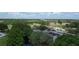 Aerial view of a clubhouse with ample parking surrounded by lush greenery and a golf course at 571 Saint Andrews Rd, Winter Haven, FL 33884