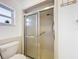 Bright bathroom with a shower, window, and tiled walls at 571 Saint Andrews Rd, Winter Haven, FL 33884