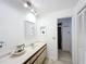 Bright bathroom with double sinks, neutral cabinets, and framed wall mirror at 571 Saint Andrews Rd, Winter Haven, FL 33884
