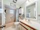 Bathroom with a neutral color scheme, shower, mirror, and vanity sink at 571 Saint Andrews Rd, Winter Haven, FL 33884