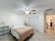 Neutral bedroom featuring a ceiling fan, neutral walls, and closet doors at 571 Saint Andrews Rd, Winter Haven, FL 33884