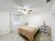 Bright bedroom featuring a ceiling fan, neutral walls, and tile floors at 571 Saint Andrews Rd, Winter Haven, FL 33884