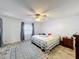 Cozy bedroom featuring a ceiling fan, wood-look flooring, and ample natural light at 571 Saint Andrews Rd, Winter Haven, FL 33884