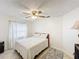 Bright bedroom featuring a ceiling fan, neutral walls, and tile floors at 571 Saint Andrews Rd, Winter Haven, FL 33884