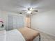 Bright bedroom featuring a ceiling fan, neutral walls, and tile floors at 571 Saint Andrews Rd, Winter Haven, FL 33884