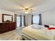 Comfortable bedroom with a ceiling fan, a slider to the outside, and natural light at 571 Saint Andrews Rd, Winter Haven, FL 33884