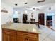 Dining room adjacent to kitchen with wood furnishings and elegant pendant lighting at 571 Saint Andrews Rd, Winter Haven, FL 33884
