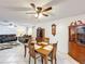 Dining room with classic wooden furniture, flowing into a comfortable living space, perfect for gatherings and everyday living at 571 Saint Andrews Rd, Winter Haven, FL 33884