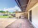 Inviting outdoor seating area with brick flooring and awning, perfect for relaxation and enjoying the property's curb appeal at 571 Saint Andrews Rd, Winter Haven, FL 33884