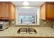 Kitchen sink beneath pass-through window, with view to the patio at 571 Saint Andrews Rd, Winter Haven, FL 33884