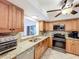 Well-lit kitchen featuring granite countertops, stainless steel appliances, and light wood cabinets at 571 Saint Andrews Rd, Winter Haven, FL 33884