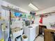 Functional laundry room with shelving, sink, washer and dryer for added convenience at 571 Saint Andrews Rd, Winter Haven, FL 33884