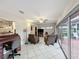 Living area with tile flooring, ceiling fan, and glass doors to the outside patio at 571 Saint Andrews Rd, Winter Haven, FL 33884