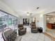 Relaxing living room with ceiling fan, tile floors, and access to an outdoor patio at 571 Saint Andrews Rd, Winter Haven, FL 33884