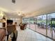 Comfortable screened-in patio room with ceiling fan, tile floors, and outdoor views at 571 Saint Andrews Rd, Winter Haven, FL 33884