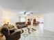 Open-concept living space featuring tile floors, comfortable seating, and a dining area, creating a welcoming and functional layout at 571 Saint Andrews Rd, Winter Haven, FL 33884