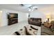 Spacious living room with tile floors and a modern rug, perfect for entertaining or relaxing in style at 571 Saint Andrews Rd, Winter Haven, FL 33884