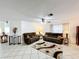 Comfortable living room featuring tile flooring, neutral walls, and cozy furnishings for a relaxing atmosphere at 571 Saint Andrews Rd, Winter Haven, FL 33884