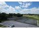 Aerial view of well-maintained tennis courts surrounded by lush greenery in a vibrant community at 571 Saint Andrews Rd, Winter Haven, FL 33884
