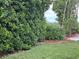 Well-maintained backyard with lush lawn, landscaping, mulch, and a paved walkway visible at 6107 Grand Oaks Se Dr, Winter Haven, FL 33884