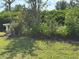 Manicured backyard features lush greenery, a bird bath, and serene landscaping at 6107 Grand Oaks Se Dr, Winter Haven, FL 33884