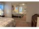 Bedroom with mirrored closet doors reflecting the room's interior, including a bed and dresser at 6107 Grand Oaks Se Dr, Winter Haven, FL 33884