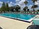 Beautiful community pool with clear blue water and plenty of seating at 6107 Grand Oaks Se Dr, Winter Haven, FL 33884
